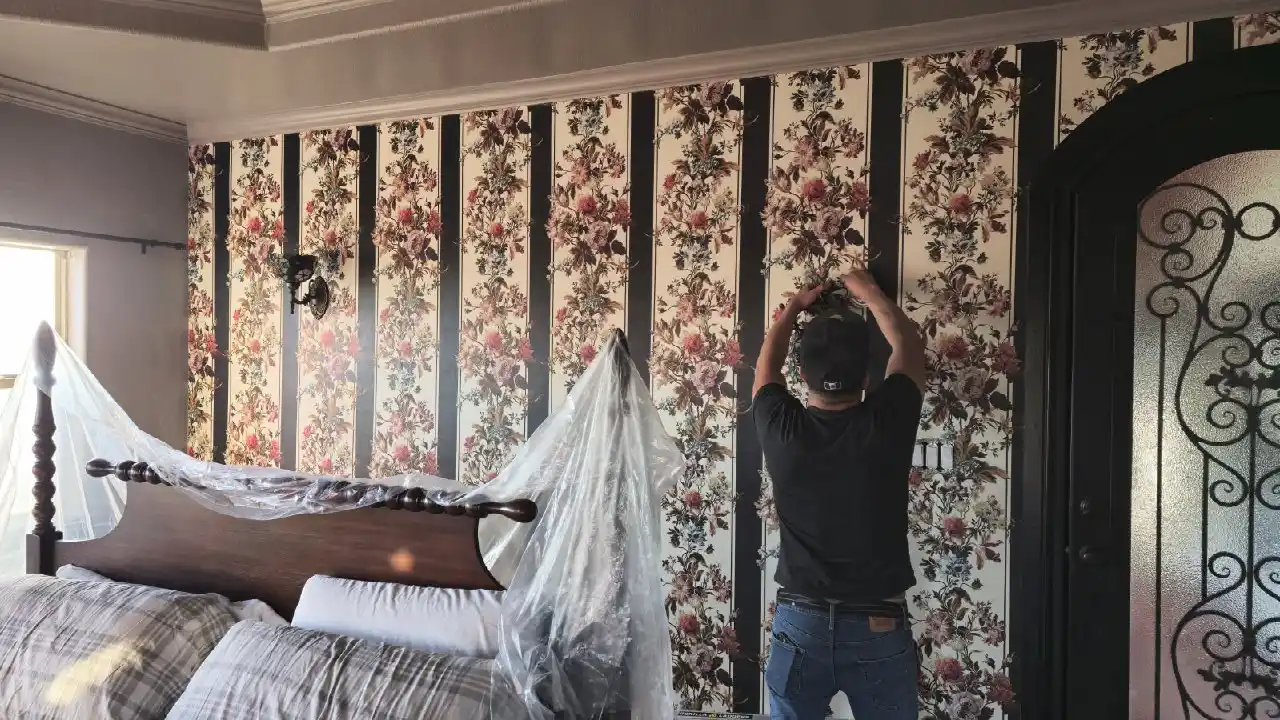 Professional wallpaper installer applying elegant wallpaper in a modern Washington DC home